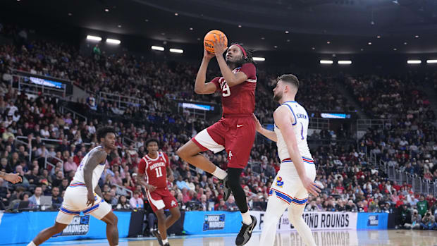 Arkansas Razorbacks forward Jonas Aidoo (9) drives to the basket against Kansas Jayhawks center Hunter Dickinson (1)