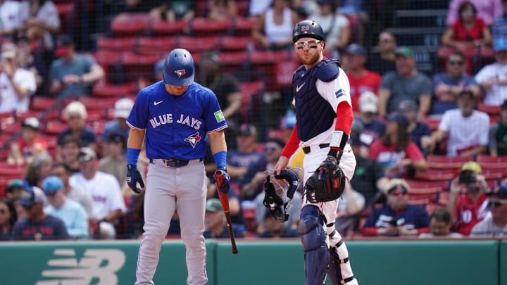 Aug 26, 2024; Boston, Massachusetts, USA; Boston Red Sox catcher Danny Jansen (28) at home plate with Toronto Blue Jays center fielder Daulton Varsho (25) pinch hitting for Jenson making history in the second inning at Fenway Park.