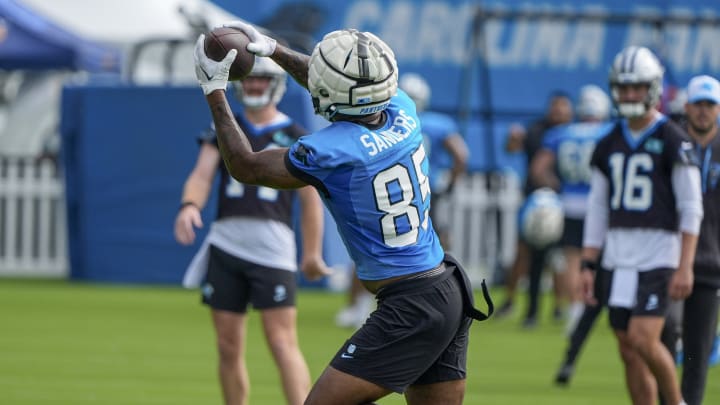 Jul 24, 2024; Charlotte, NC, USA; Carolina Panthers tight end Ja'Tavion Sanders (85) catches a ball thrown by quarterback Andy Dalton (14) at Carolina Panthers Practice Fields.