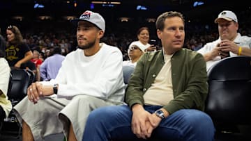 Phoenix Suns guard Devon Booker sits with Phoenix Mercury owner Mat Ishbia.