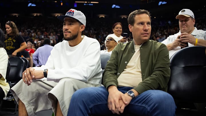 Phoenix Suns guard Devon Booker sits with Phoenix Mercury owner Mat Ishbia.