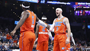 Dec 10, 2024; Oklahoma City, Oklahoma, USA; Oklahoma City Thunder guard Alex Caruso (9) celebrates with Oklahoma City Thunder guard Luguentz Dort (5) after scoring against the Dallas Mavericks during the second quarter at Paycom Center. Mandatory Credit: Alonzo Adams-Imagn Images