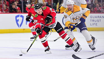 Feb 7, 2025; Chicago, Illinois, USA; Chicago Blackhawks center Connor Bedard (98) passes with the puck against the Nashville Predators during the first period at the United Center. Mandatory Credit: Daniel Bartel-Imagn Images