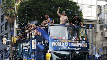 Nov 3, 2025; Los Angeles, CA, USA;  Los Angeles Dodgers first baseman Enrique Hernandez (middle) and second baseman Miguel Rojas (right) acknowledges the crowd during the World Series championship parade at downtown Los Angeles. Mandatory Credit: Kiyoshi Mio-Imagn Images