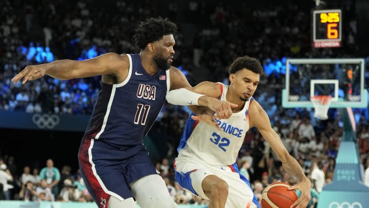 Aug 10, 2024; Paris, France; France power forward Victor Wembanyama (32) controls the ball against United States centre Joel Embiid (11) in the second half in the men's basketball gold medal game during the Paris 2024 Olympic Summer Games at Accor Arena. Mandatory Credit: Kyle Terada-USA TODAY Sports