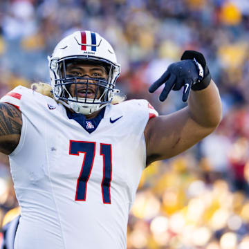 Nov 25, 2023; Tempe, Arizona, USA; Arizona Wildcats offensive lineman Jonah Savaiinaea (71) celebrates a touchdown against the Arizona State Sun Devils in the second half of the Territorial Cup at Mountain America Stadium. Mandatory Credit: Mark J. Rebilas-Imagn Images