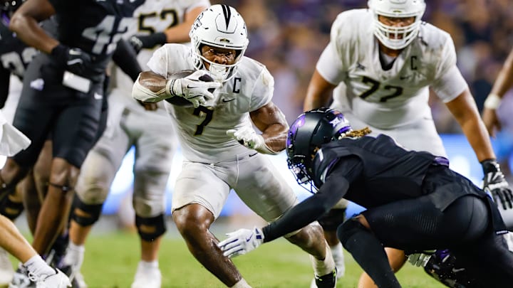 Sep 14, 2024; Fort Worth, Texas, USA; UCF Knights running back RJ Harvey (7) breaks through the line of scrimmage during the fourth quarter against the TCU Horned Frogs at Amon G. Carter Stadium. Mandatory Credit: Andrew Dieb-Imagn Images