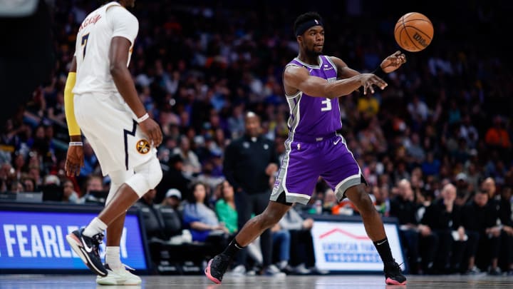 Apr 9, 2023; Denver, Colorado, USA; Sacramento Kings guard Terence Davis III (3) passes the ball as Denver Nuggets guard Reggie Jackson (7) guards in the fourth quarter at Ball Arena. Mandatory Credit: Isaiah J. Downing-USA TODAY Sports