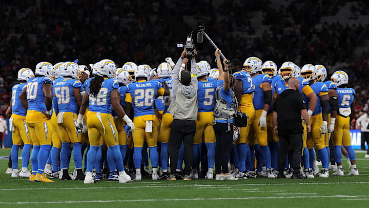 Los Angeles Chargers players in a huddle before game against the Kansas City Chiefs.