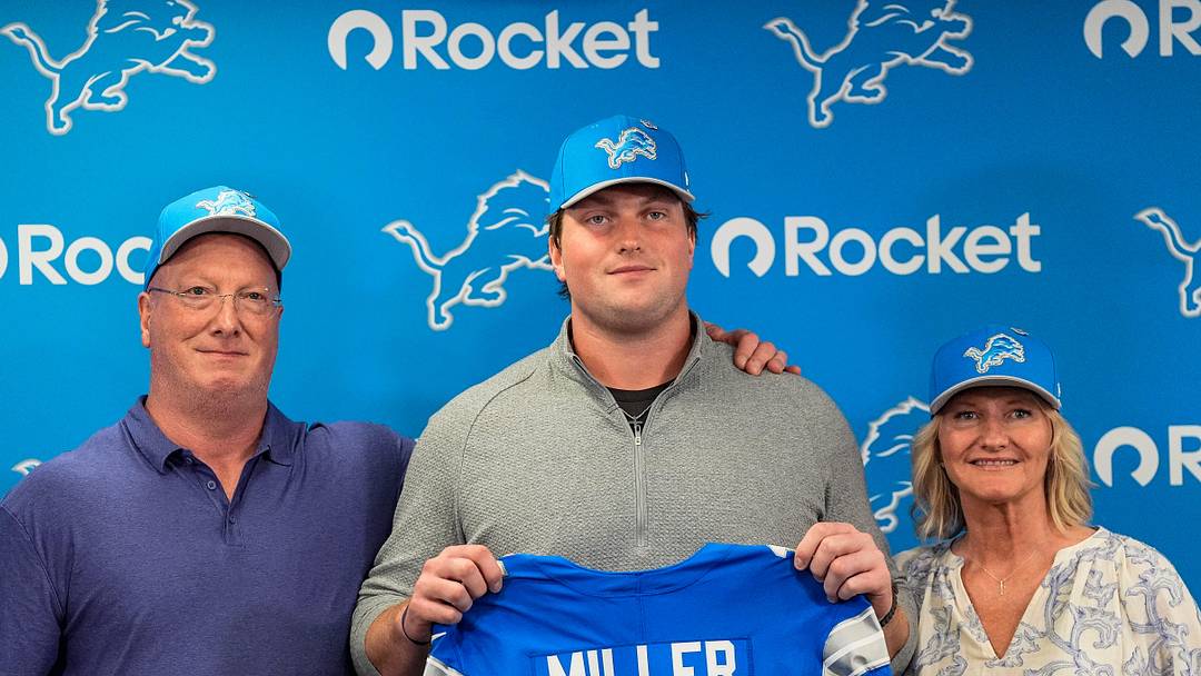 Detroit Lions first round draft Blake Miller, center, poses for a photo with his father Chris Miller, left, and mother Karen Miller at his introductory press conference at Meijer Performance Center in Allen Park on Friday, April 24, 2026.