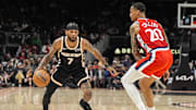 Dec 3, 2025; Atlanta, Georgia, USA; Atlanta Hawks guard Nickeil Alexander-Walker (7) dribbles against LA Clippers forward John Collins (20) during the first half at State Farm Arena. Mandatory Credit: Dale Zanine-Imagn Images
