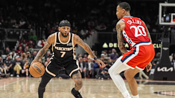 Dec 3, 2025; Atlanta, Georgia, USA; Atlanta Hawks guard Nickeil Alexander-Walker (7) dribbles against LA Clippers forward John Collins (20) during the first half at State Farm Arena. Mandatory Credit: Dale Zanine-Imagn Images
