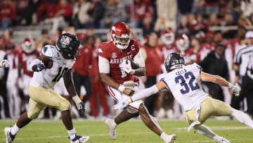 Nov 18, 2023; Fayetteville, Arkansas, USA; Arkansas Razorbacks quarterback KJ Jefferson (1) rushes in the second quarter as FIU Panthers linebacker Donovan Manuel (10) and defensive back Bobby Salla Jr (32) defend at Donald W. Reynolds Razorback Stadium. Mandatory Credit: Nelson Chenault-USA TODAY Sports