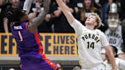 Purdue Boilermakers guard Jack Benter (14) attempts to block Evansville Purple Aces guard Keishon Porter (1) 