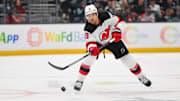 Jan 6, 2025; Seattle, Washington, USA; New Jersey Devils defenseman Johnathan Kovacevic (8) passes the puck against the Seattle Kraken during the second period at Climate Pledge Arena. Mandatory Credit: Steven Bisig-Imagn Images