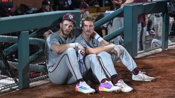 Jun 24, 2024; Omaha, NE, USA;  Texas A&M Aggies third baseman Gavin Grahovac (9) and designated hitter Hayden Schott (5) look over the field after the loss against the Tennessee Volunteers at Charles Schwab Field Omaha.