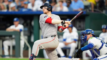 Aug 7, 2024; Kansas City, Missouri, USA; Boston Red Sox catcher Danny Jansen (28) hits a home run against the Kansas City Royals during the fourth inning at Kauffman Stadium. Mandatory Credit: Jay Biggerstaff-USA TODAY Sports