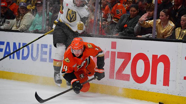 May 8, 2026; Anaheim, California, USA; Vegas Golden Knights right wing Cole Smith (22) hits Anaheim Ducks defenseman Drew Helleson (14) while playing for the puck during the third period in game three of the second round of the 2026 Stanley Cup Playoffs at Honda Center. Mandatory Credit: Gary A. Vasquez-Imagn Images