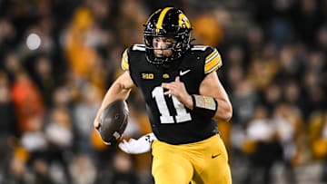 Nov 22, 2025; Iowa City, Iowa, USA; Iowa Hawkeyes quarterback Mark Gronowski (11) scrambles for yards against the Michigan State Spartans during the fourth quarter at Kinnick Stadium. Mandatory Credit: Jeffrey Becker-Imagn Images