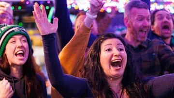 Notre Dame fans celebrate from The Linebacker Lounge in South Bend after Notre Dame scored a touchdown