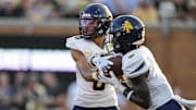 Aug 29, 2024; Winston-Salem, North Carolina, USA;  North Carolina A&T Aggies quarterback Kevin White (0) hands off to running back Kenji Christian (7) during the first half against the Wake Forest Demon Deacons at Allegacy Federal Credit Union Stadium. Mandatory Credit: Jim Dedmon-Imagn Images
