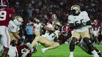 Sep 7, 2024; Tuscaloosa, Alabama, USA; South Florida Bulls quarterback Byrum Brown (17) clutches the ball as he is brought down by Alabama Crimson Tide linebacker Deontae Lawson (0) during the third quarter at Bryant-Denny Stadium. Mandatory Credit: William McLelland-Imagn Images
