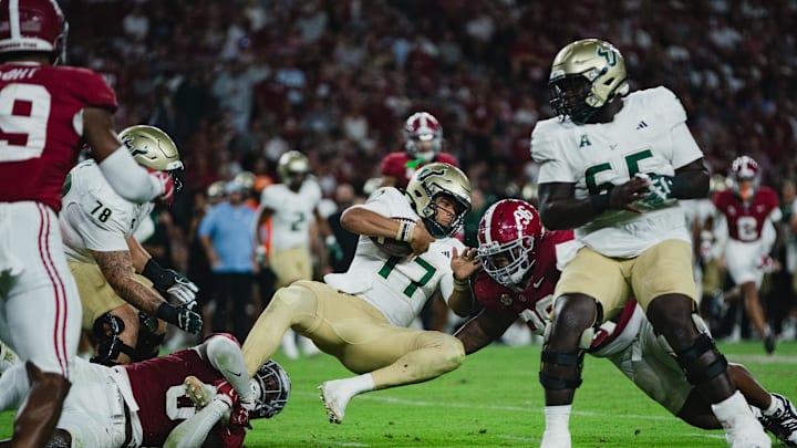 Sep 7, 2024; Tuscaloosa, Alabama, USA; South Florida Bulls quarterback Byrum Brown (17) clutches the ball as he is brought down by Alabama Crimson Tide linebacker Deontae Lawson (0) during the third quarter at Bryant-Denny Stadium. Mandatory Credit: William McLelland-Imagn Images