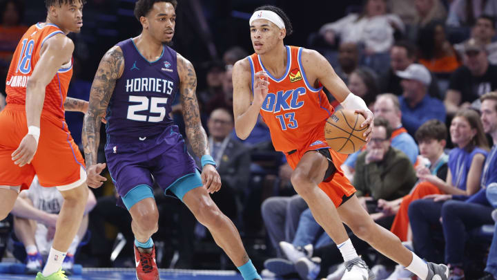 Feb 2, 2024; Oklahoma City, Oklahoma, USA; Oklahoma City Thunder forward Ousmane Dieng (13) moves past Charlotte Hornets forward P.J. Washington (25) during the second half at Paycom Center. Mandatory Credit: Alonzo Adams-USA TODAY Sports