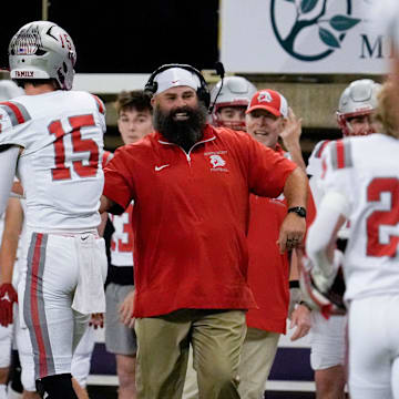 North Scott’s Kye Smith (15) celebrates with a coach after scoring against North Polk Thursday, Nov. 14, 2024 at the UNI-Dome in Cedar Falls, Iowa.