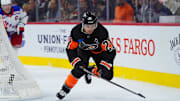 Nov 29, 2024; Philadelphia, Pennsylvania, USA; Philadelphia Flyers center Scott Laughton (21) reaches for the puck against the New York Rangers in the third period at Wells Fargo Center. Mandatory Credit: Kyle Ross-Imagn Images