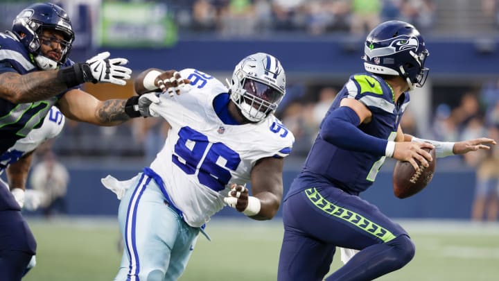 Aug 19, 2023; Seattle, Washington, USA; Dallas Cowboys defensive tackle Neville Gallimore (96) pressures Seattle Seahawks quarterback Drew Lock (2) while being blocked by offensive tackle Abraham Lucas (72) during the second quarter at Lumen Field. Mandatory Credit: Joe Nicholson-USA TODAY Sports