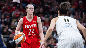 Indiana Fever guard Caitlin Clark (22) dribbles  the ball while Chicago Sky guard Kia Nurse (11) defends in the first half at Gainbridge Fieldhouse.