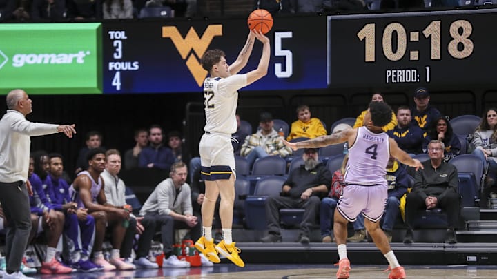 Jan 27, 2026; Morgantown, West Virginia, USA; West Virginia Mountaineers guard Treysen Eaglestaff (52) shoots a three pointer during the first half against the Kansas State Wildcats at Hope Coliseum. Mandatory Credit: Ben Queen-Imagn Imagesa