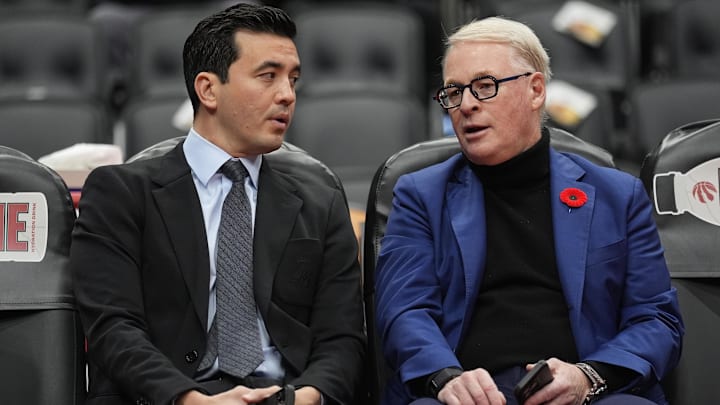 Nov 4, 2025; Toronto, Ontario, CAN; Toronto Raptors general manager Bobby Webster (left) and Maple Leaf Sports and Entertainment president and CEO Keith Pelley (right) talk during warm up before a game against the Milwaukee Bucks at Scotiabank Arena. Mandatory Credit: John E. Sokolowski-Imagn Images
