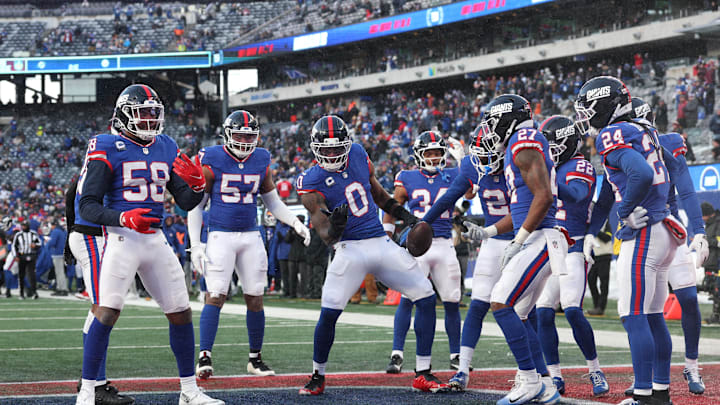 Dec 14, 2025; East Rutherford, New Jersey, USA;  New York Giants linebacker Brian Burns (0) celebrates a fumble recovery with teammates during the fourth quarter against the Washington Commanders at MetLife Stadium. Mandatory Credit: Vincent Carchietta-Imagn Images