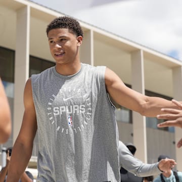 Jun 28, 2025; San Antonio, TX, USA; San Antonio Spurs first round draft pick Carter Bryant greets fans at Victory Capital Performance Center. Mandatory Credit: Scott Wachter-Imagn Images