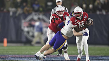 Dec 28, 2024; Annapolis, MD, USA;  East Carolina Pirates defensive lineman J.D. Lampley (9) sacks North Carolina State Wolfpack quarterback CJ Bailey (16) during the first half of the Go Bowling Military Bowl at Navy-Marine Corps Memorial Stadium. Mandatory Credit: Tommy Gilligan-Imagn Images