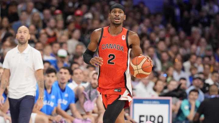 Jul 27, 2024; Villeneuve-d'Ascq, France; Canada guard Shai Gilgeous-Alexander (2) controls the ball against Greece in the first quarter during the Paris 2024 Olympic Summer Games at Stade Pierre-Mauroy. Mandatory Credit: John David Mercer-USA TODAY Sports