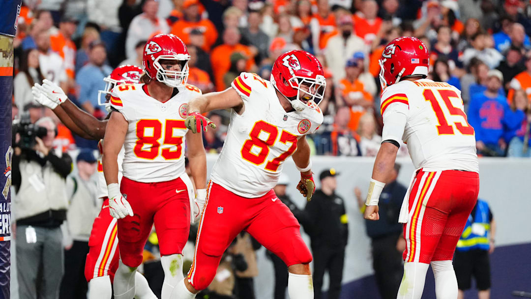 Nov 16, 2025; Denver, Colorado, USA; Kansas City Chiefs tight end Travis Kelce (87) celebrates his touchdown with quarterback Patrick Mahomes (15) and tight end Robert Tonyan (85) in the fourth quarter at Empower Field at Mile High. Mandatory Credit: Ron Chenoy-Imagn Images