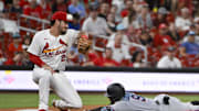 Jul 29, 2025; St. Louis, Missouri, USA;  Miami Marlins second baseman Xavier Edwards (9) slides safely past St. Louis Cardinals third baseman Nolan Arenado (28) for a one run triple during the sixth inning at Busch Stadium. Mandatory Credit: Jeff Curry-Imagn Images