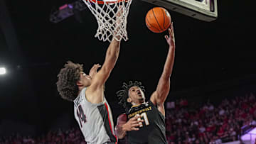 Mar 8, 2025; Athens, Georgia, USA; Vanderbilt Commodores guard AJ Hoggard (11) goes to the basket against Georgia Bulldogs forward Asa Newell (14) during the second half at Stegeman Coliseum. Mandatory Credit: Dale Zanine-Imagn Images