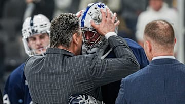 Penn State men's hockey coach Guy Gadowsky congratulates goaltender Arsenii Sergeev after the Nittany Lions' win over UConn in the NCAA Tournament Allentown Regional final.