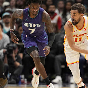 Mar 18, 2025; Charlotte, North Carolina, USA; Atlanta Hawks guard Trae Young (11) handles the ball against Charlotte Hornets guard Damion Baugh (7) during second quarter at Spectrum Center. Mandatory Credit: Jim Dedmon-Imagn Images