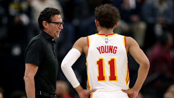 Atlanta Hawks head coach Quin Snyder speaks with Trae Young #11.