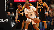 Dec 3, 2024; Phoenix, Arizona, USA; San Antonio Spurs guard Chris Paul (right) controls the ball against Phoenix Suns guard Bradley Beal in the second half of an NBA Cup game at Footprint Center. Mandatory Credit: Mark J. Rebilas-Imagn Images