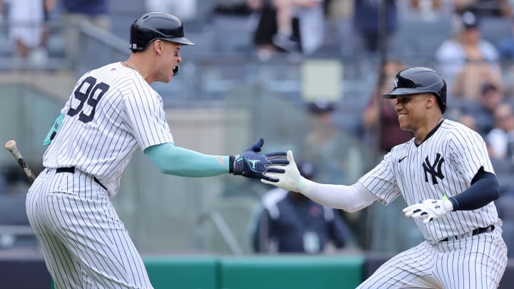 Jul 22, 2024; Bronx, New York, USA; New York Yankees right fielder Juan Soto (22) celebrates his three run home run against the Tampa Bay Rays with designated hitter Aaron Judge (99) during the eighth inning at Yankee Stadium. Mandatory Credit: Brad Penner-USA TODAY Sports