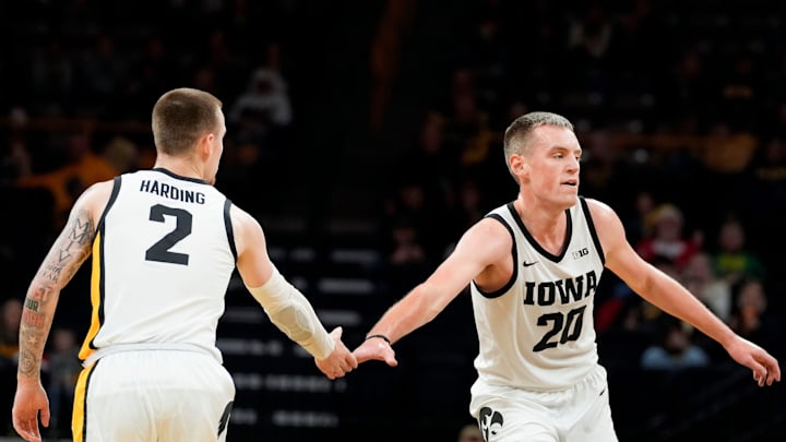 Iowa Hawkeyes guard Brock Harding (2) high-fives teammate Payton Sandfort (20) during a game against the New Orleans Privateers Sunday, Dec. 15, 2024 at Carver-Hawkeye Arena in Iowa City, Iowa. Iowa Hawkeyes guard Brock Harding (2) high-fives teammate Payton Sandfort (20) during a game against the New Orleans Privateers Sunday, Dec. 15, 2024 at Carver-Hawkeye Arena in Iowa City, Iowa.