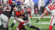 Dec 22, 2024; Atlanta, Georgia, USA; Atlanta Falcons linebacker JD Bertrand (40) tackles New York Giants wide receiver Wan'Dale Robinson (17) during the second half at Mercedes-Benz Stadium.  