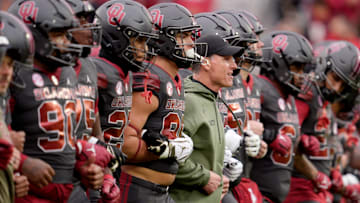 Oklahoma coach Brent Venables walks with his team before OU's contest against Missouri.