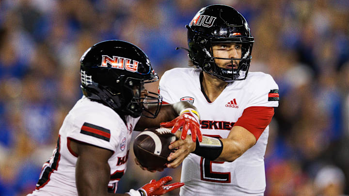 Sep 24, 2022; Lexington, Kentucky, USA; Northern Illinois Huskies quarterback Ethan Hampton (2) hands the ball off to running back Harrison Waylee (30) during the second quarter against the Kentucky Wildcats at Kroger Field. Mandatory Credit: Jordan Prather-Imagn Images